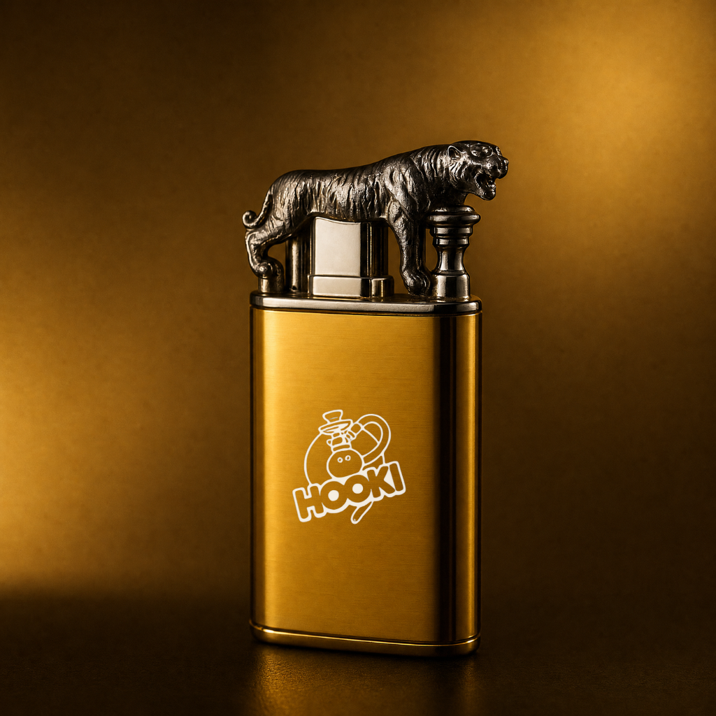 A gold rectangular lighter with a silver tiger figurine on top and a white 'HOOKi' logo on the front, set against a warm gold gradient background.